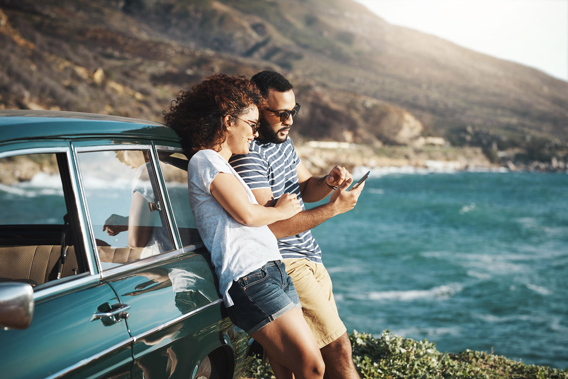 Travellers planning a route by the sea